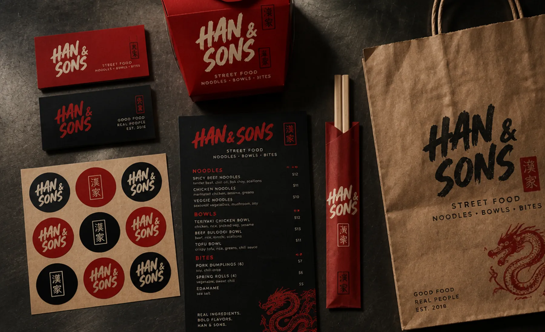 Example branding for an invented street food business, Han and Sons: red and black business cards with a brush wordmark, a noodle box, a menu card, round stickers and a paper bag